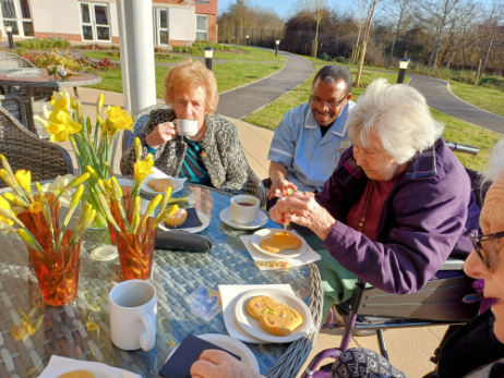 residents outside decorating gingerbread