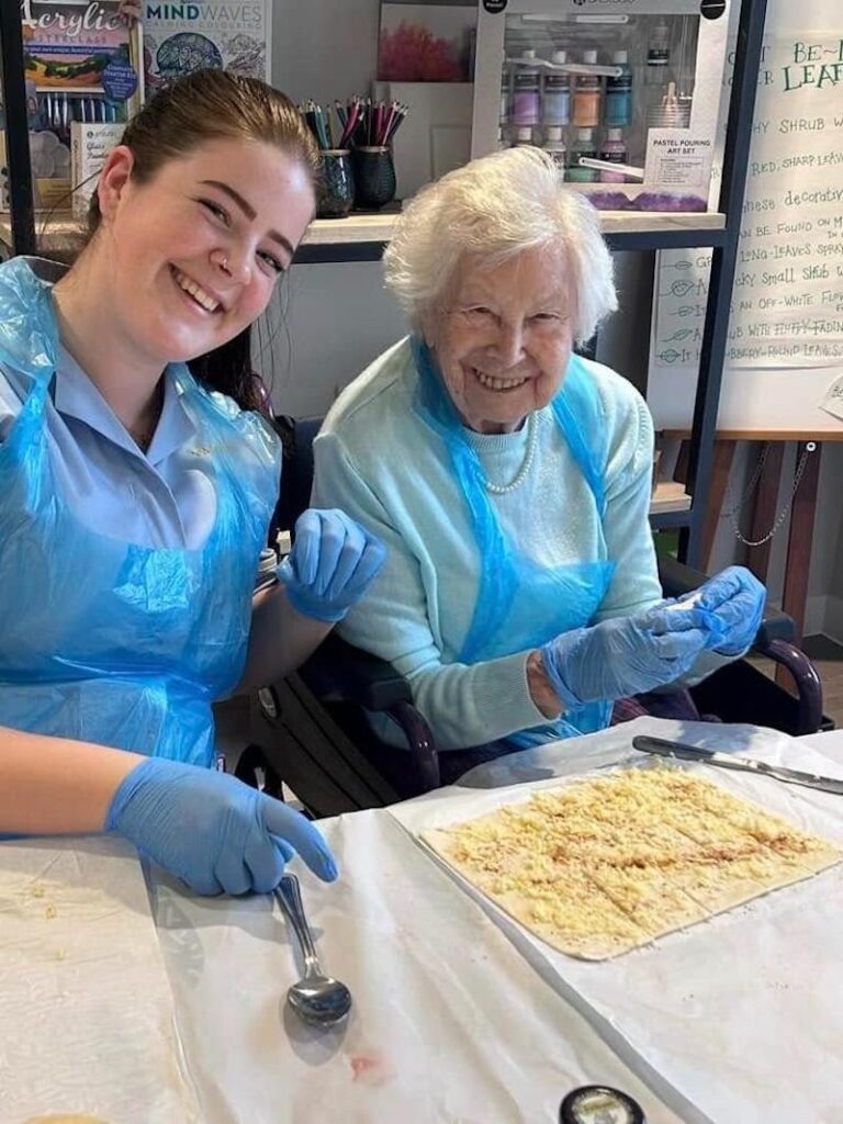 resident doing baking with a carer