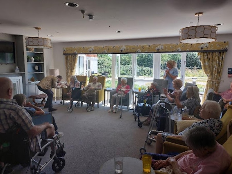residents sat enjoying a performance from our entertainer