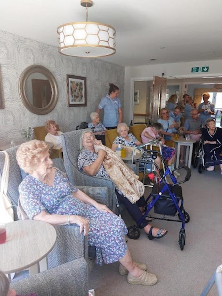 residents enjoying a performance from local entertainer