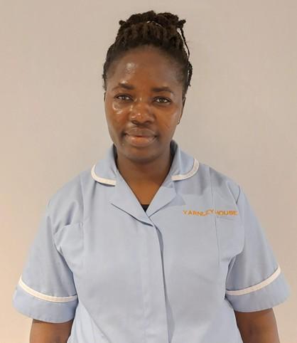 lady in care uniform posing for staff photo