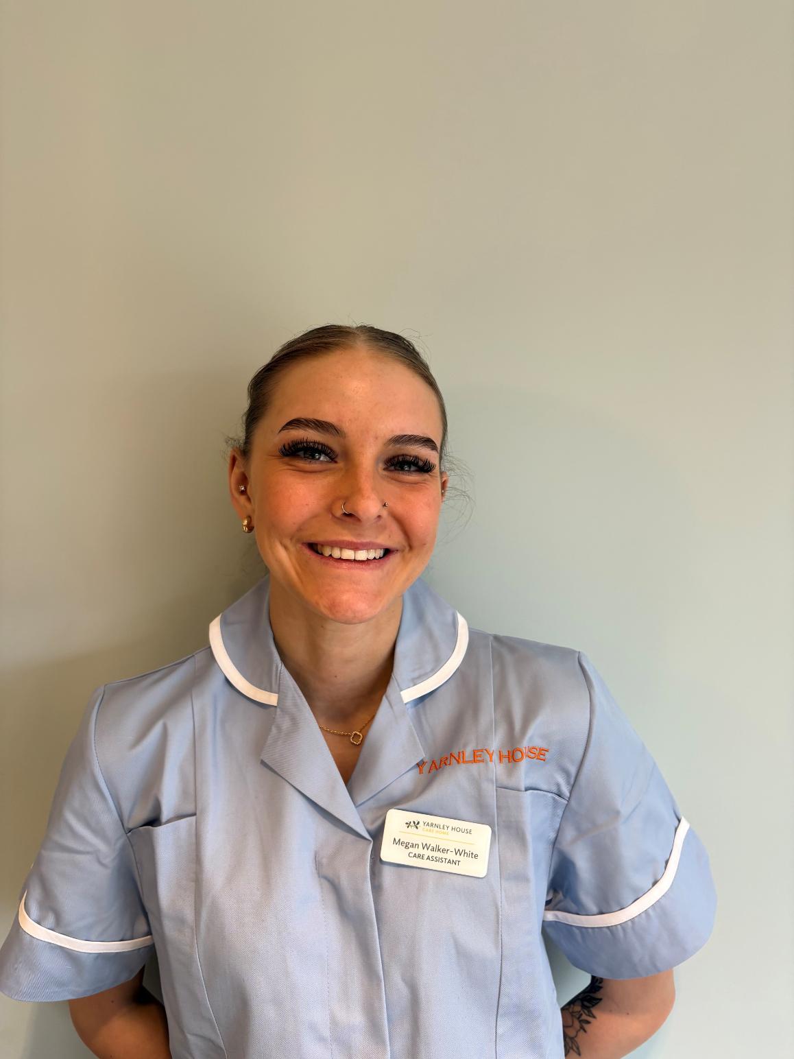 lady in care uniform posing for staff photo