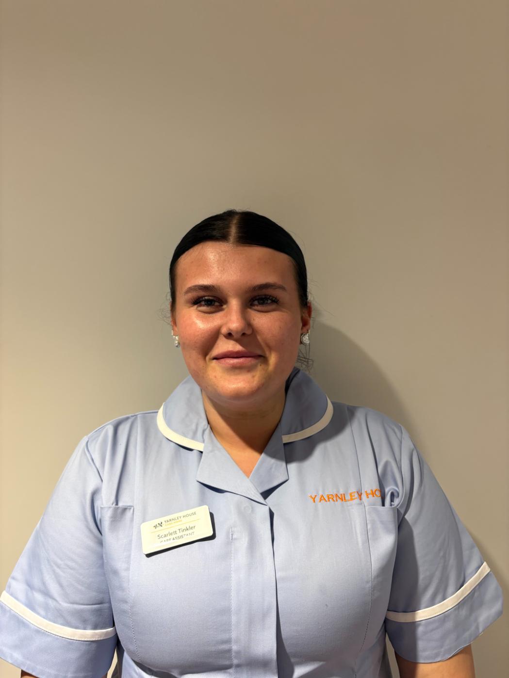 lady in care uniform posing for staff photo