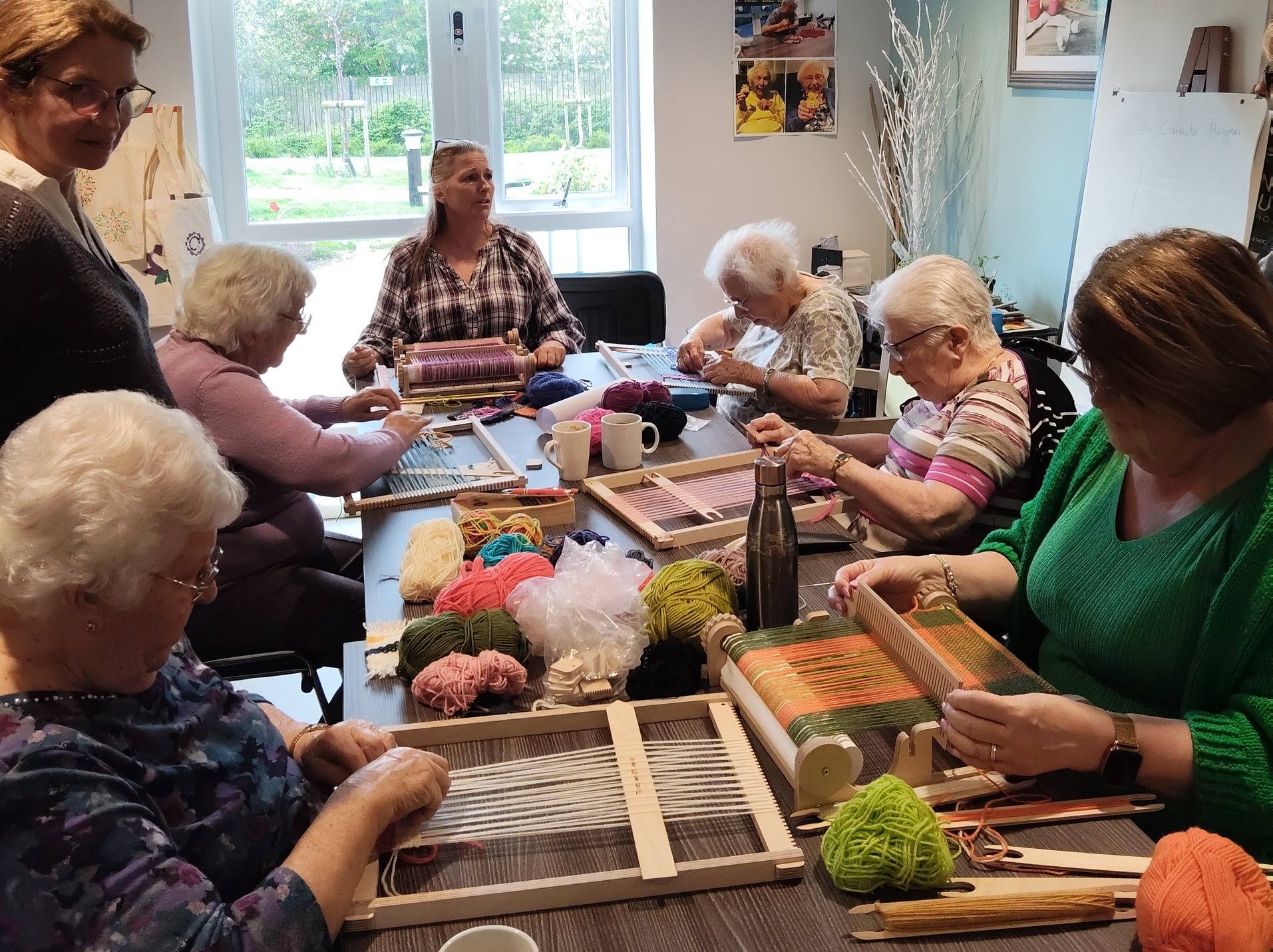 group of older ladies weaving