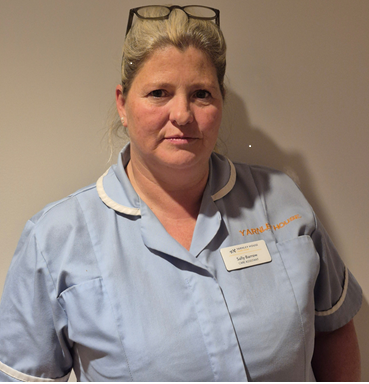 blonde lady in care uniform posing for staff photo