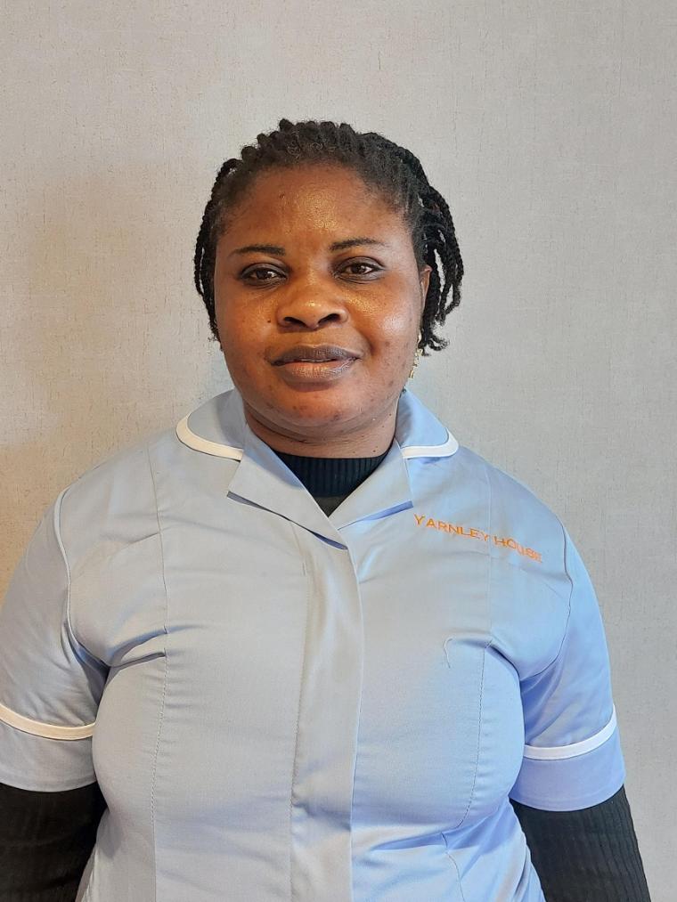 lady in care uniform posing for staff photo