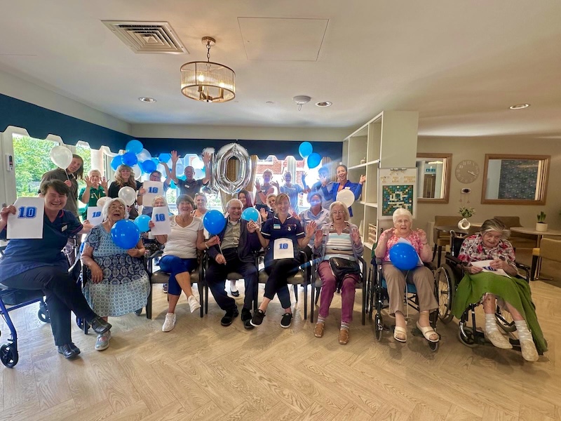 our team and residents celebrating our carehome.co.uk score