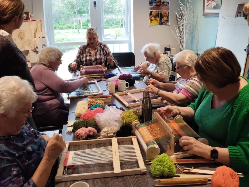 group of older ladies weaving