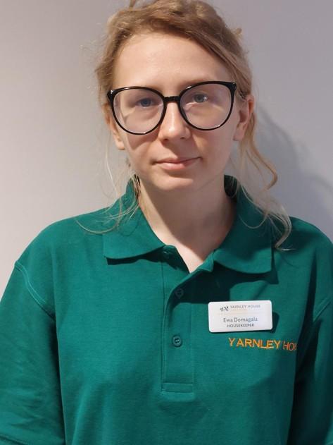 lady with glasses posing for staff photo