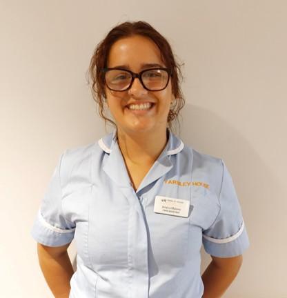 lady with glasses posing for staff photo
