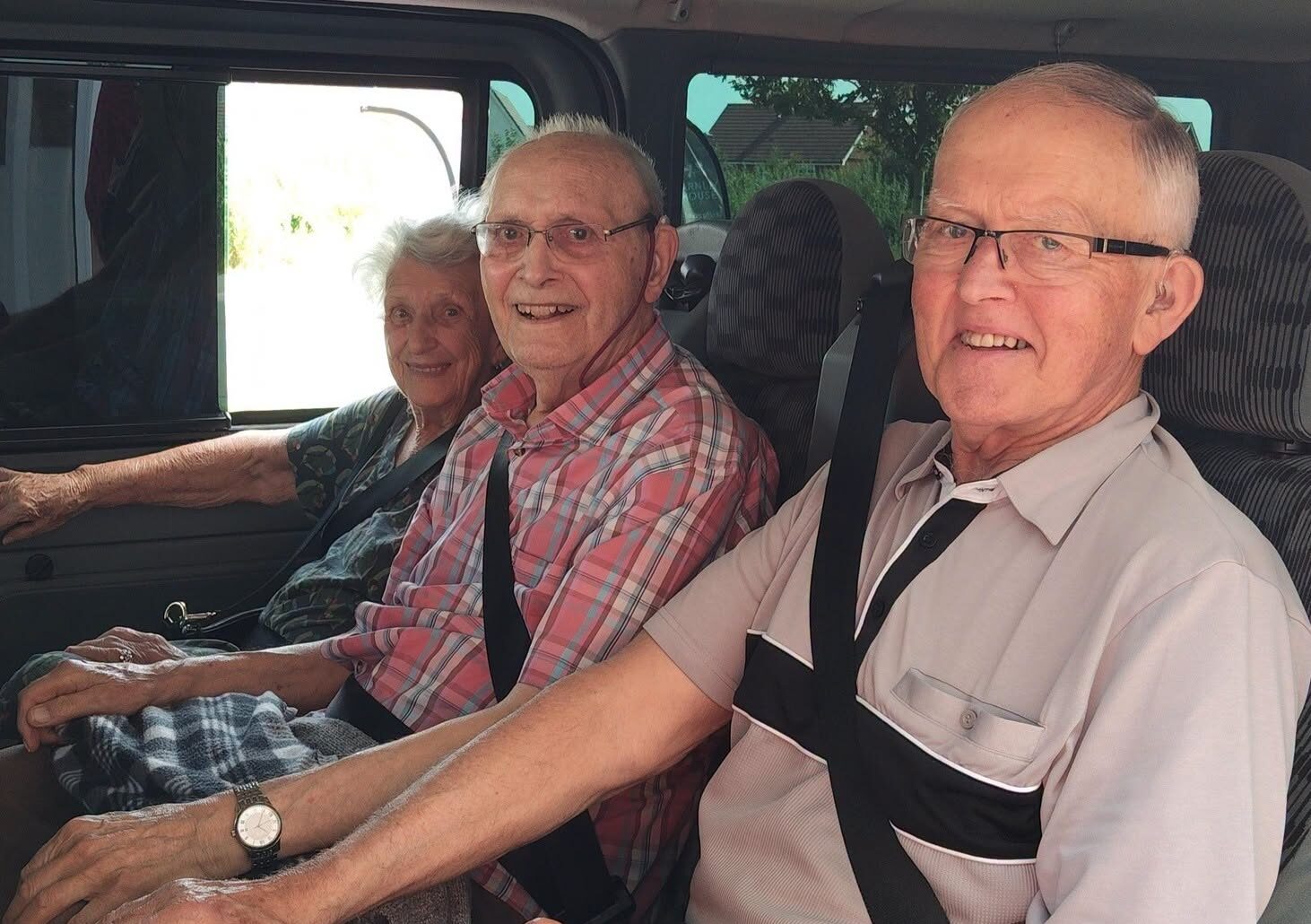 older adults sat in a minibus